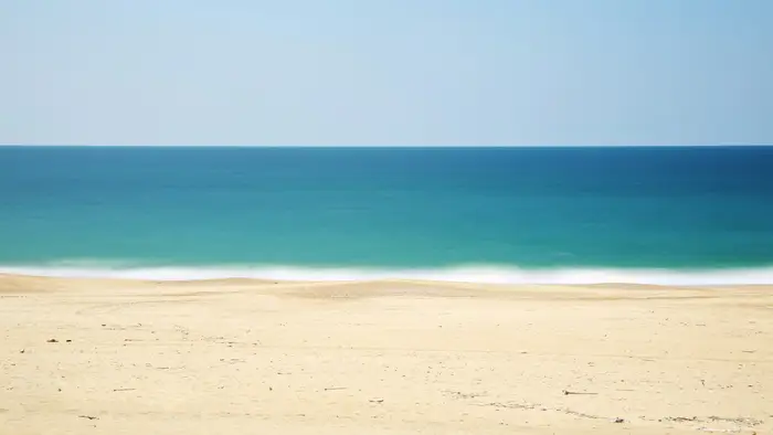 A sunny beach, representing the exciting outings and celebrations where children are naturally energetic